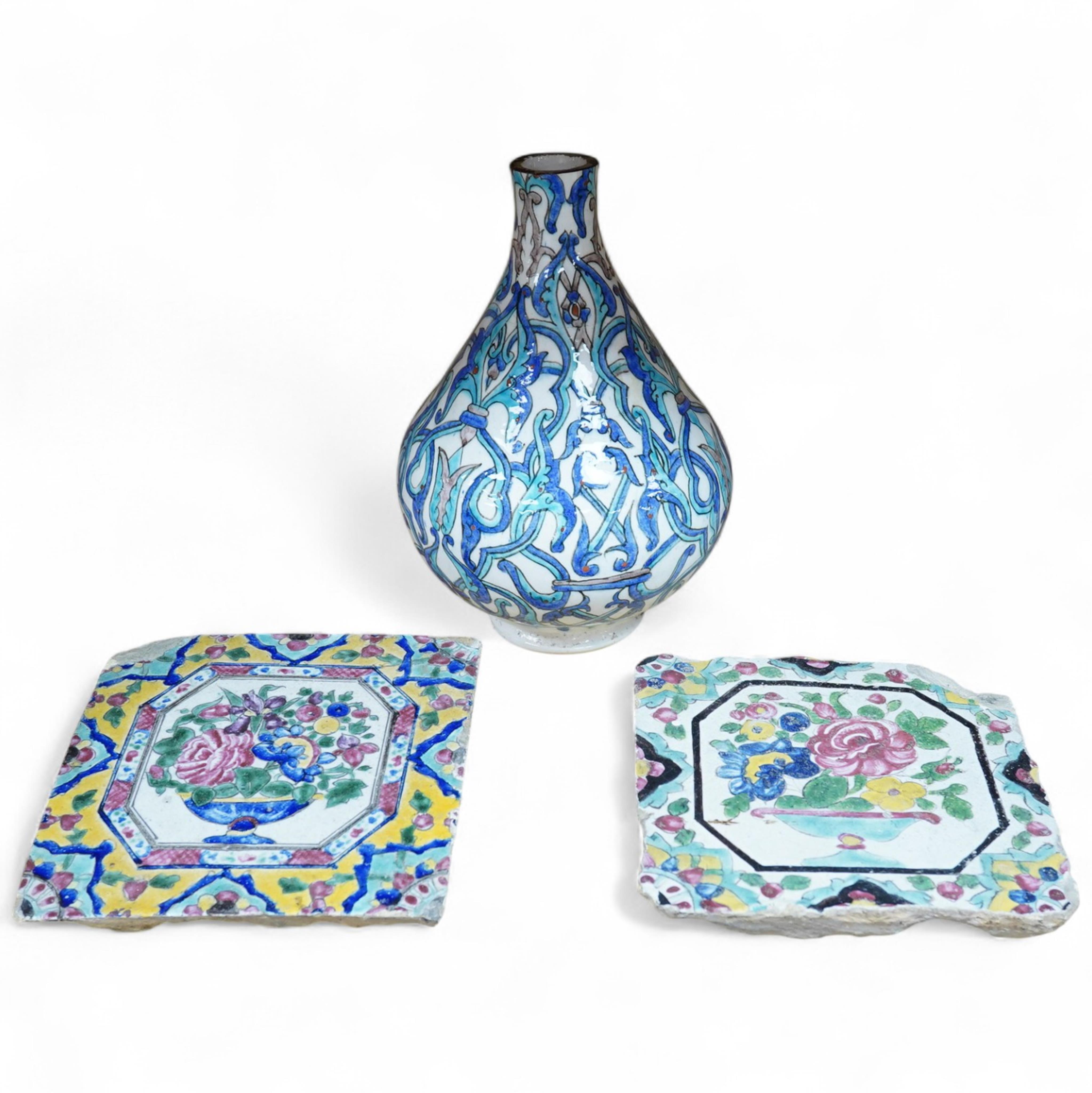 A Persian stoneware vase (reduced) and two floral tiles